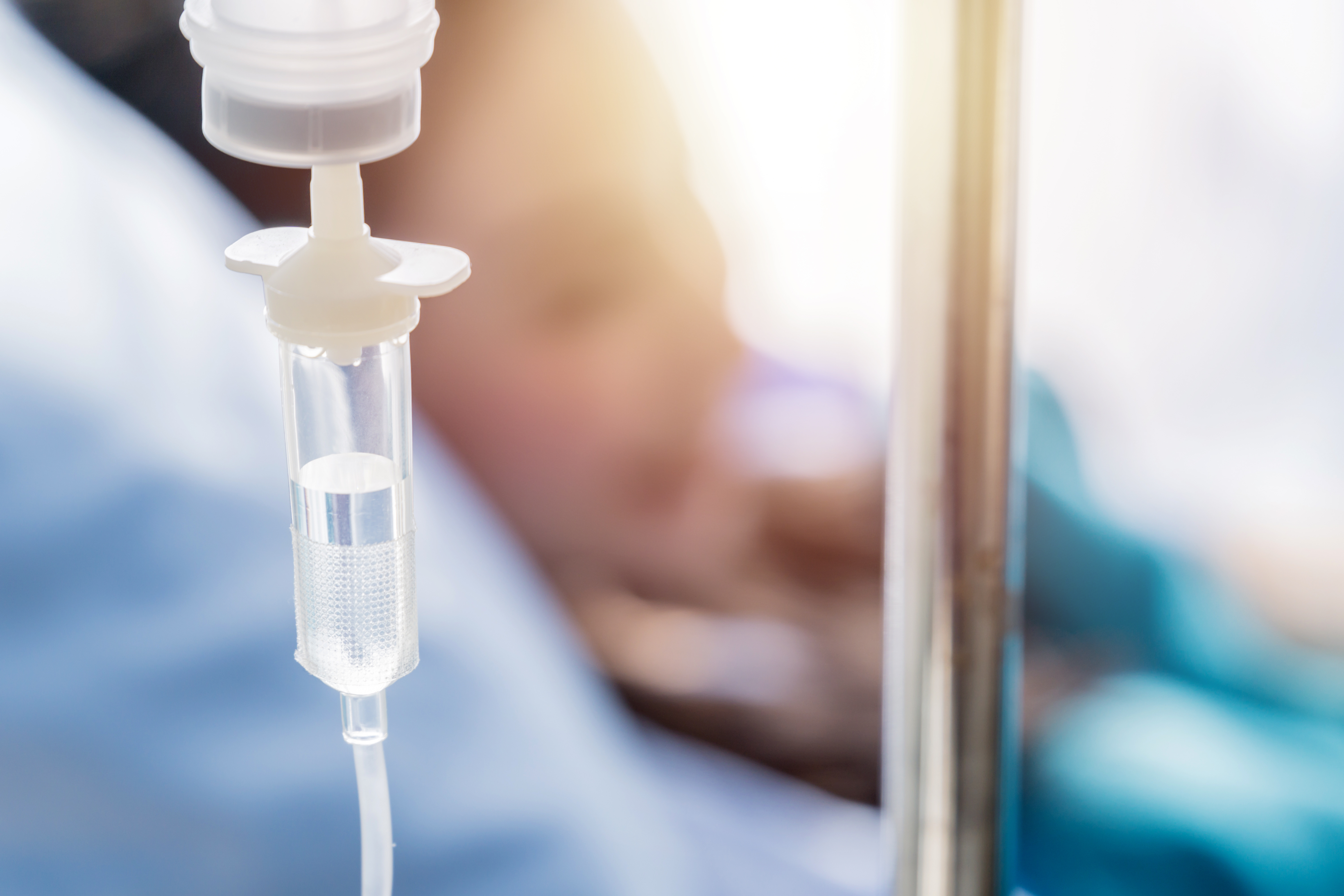 woman in hospitan bed with an iv drip