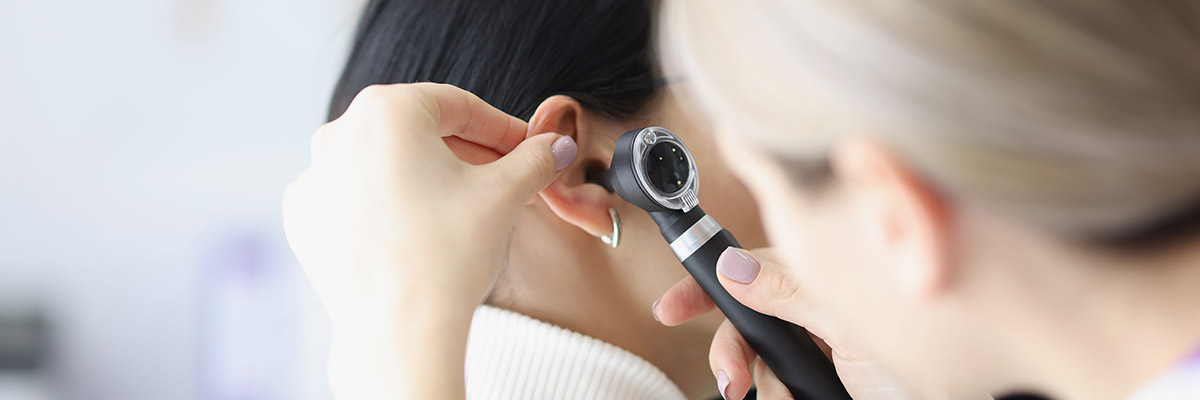 Doctor giving a woman an ear checkup