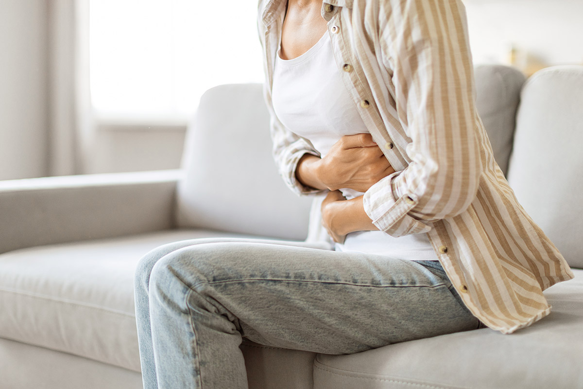 woman holding her stomach in pain