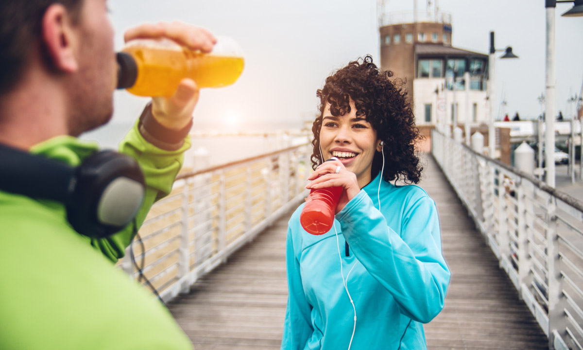 a couple drinking sports beverages